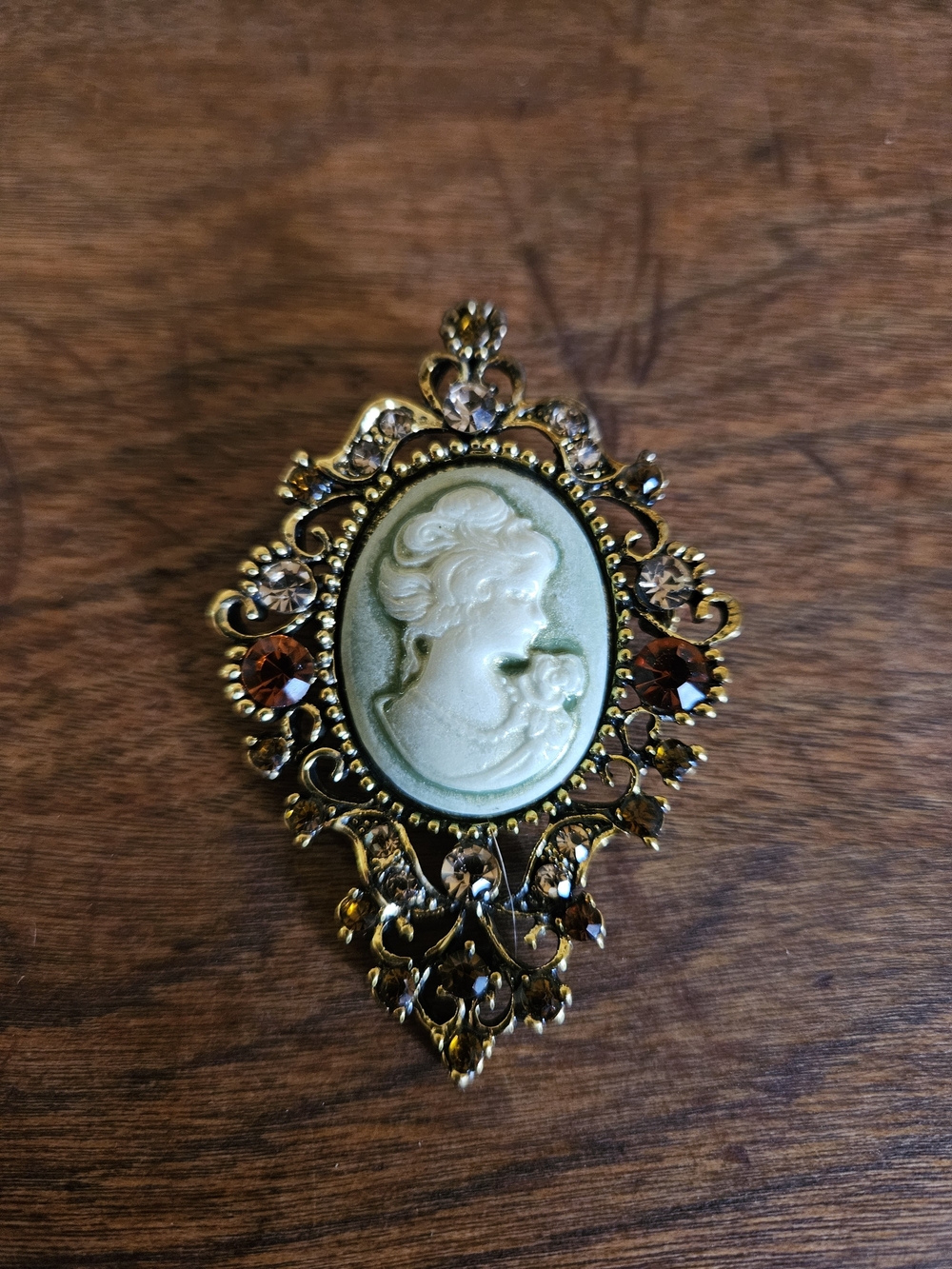 Vintage-Inspired Green Cameo Filigree Brooch with Amber Accents